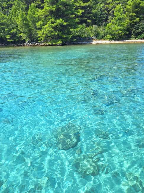 Zadar: Half-Day Island-Hopping and Lagoons Cruise with Fruit - Ugljan Island beach time: sandy feet and a breather